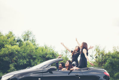 People traveling in car against sky