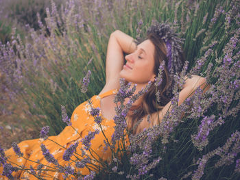 Portrait of young woman sitting on field