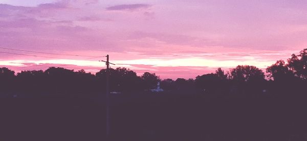 Silhouette trees against sky during sunset