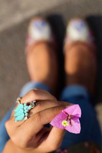 Close-up of woman holding purple flower