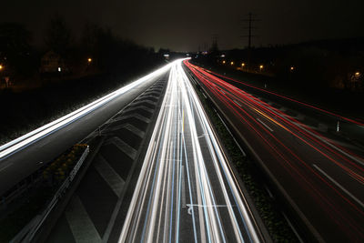 High angle view of light trails on road at night