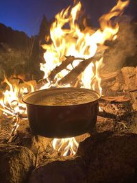 Close-up of burning fire on log at night