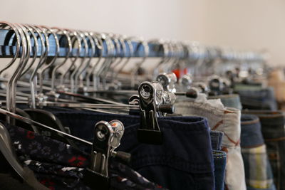 Cloths hanging on coathangers in shop