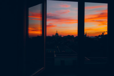 Silhouette buildings against sky during sunset