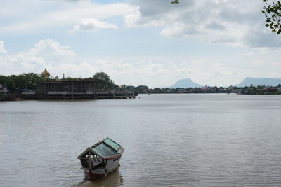 Boat in river against sky