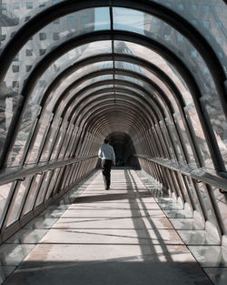 Rear view of man walking in building