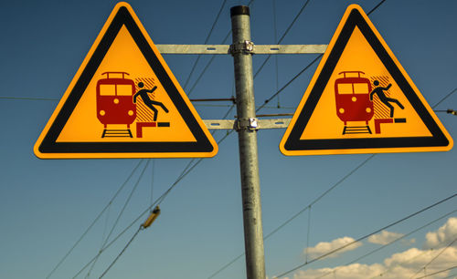 Low angle view of road sign against sky