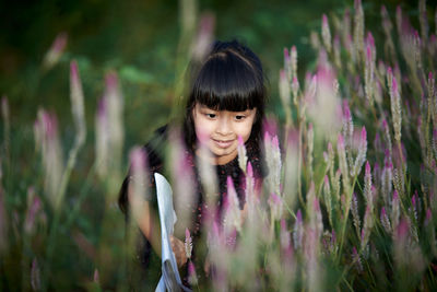 Portrait of a smiling young woman on field