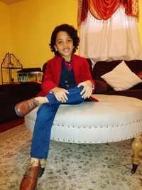 Portrait of smiling girl sitting at home