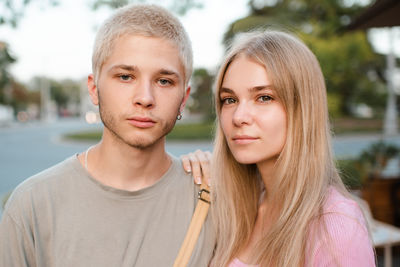 Romantic love couple of teenage girl and boy 17-18 year old together outdoor. happy teenager smiling