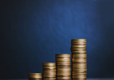 Stack of coin against blue background