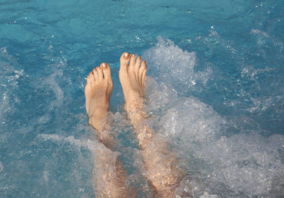 Low section of person in swimming pool