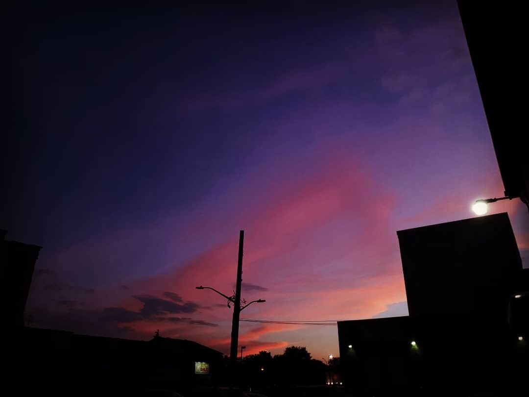 sky, silhouette, building exterior, architecture, illuminated, sunset, built structure, no people, night, low angle view, nature, cloud - sky, city, street, building, outdoors, street light, orange color, dusk, beauty in nature