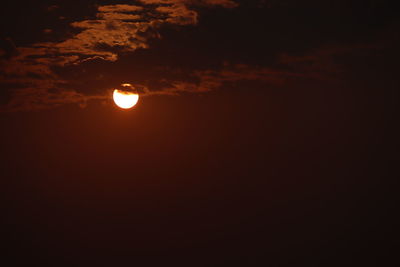 Low angle view of moon at sunset