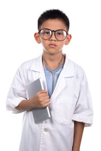 Portrait of smiling young man standing against white background