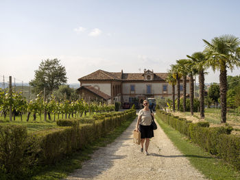 Woman walking on graveled road in winery