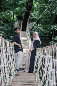 Couple standing on footbridge