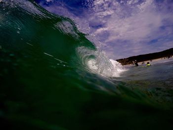 Low angle view of sea waves against sky