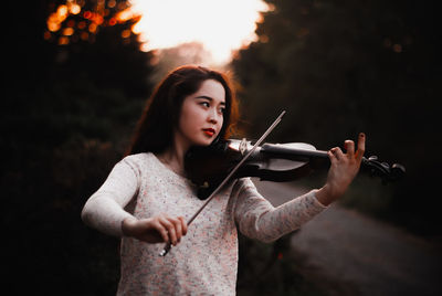 Portrait of beautiful young woman standing outdoors