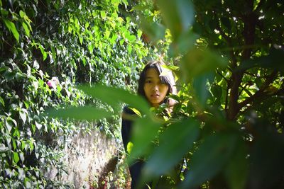 Portrait of smiling girl amidst plants