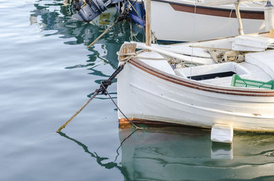 Boat moored in sea against sky