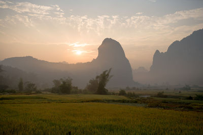 Scenic view of field against sky during sunset