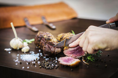 Close-up of person preparing food on cutting board