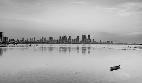 Scenic view of sea and buildings against sky