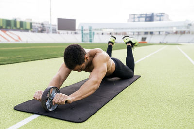 Side view of man lying on grass