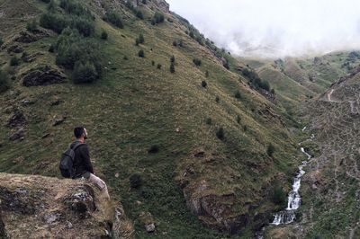 Rear view of man standing on mountain