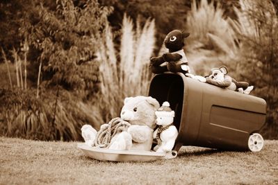 Toy sitting on sofa in field