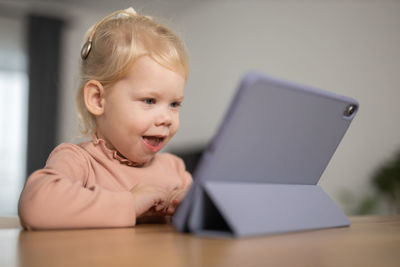 Close-up of boy using laptop at home