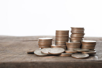 Coins on table against white background