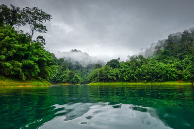 Scenic view of swimming pool by lake against sky