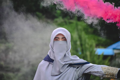 Portrait of young man standing outdoors