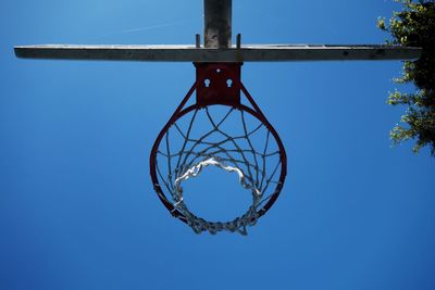 Low angle view of basketball hoop against blue sky