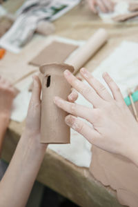 Women's hands knead clay, drawing elements of the product. production of ceramic products 