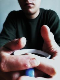 Midsection of man holding can at home