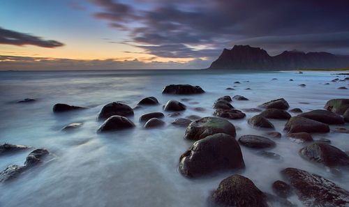 View of calm beach at sunset