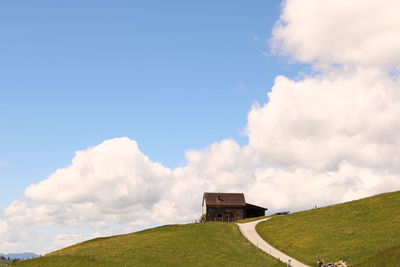 Built structure on field against sky