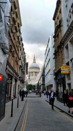 View of cathedral against cloudy sky in city