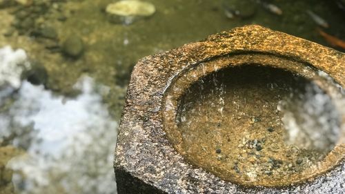 High angle view of rusty metal on rock