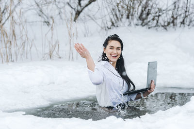 Portrait of young woman using mobile phone