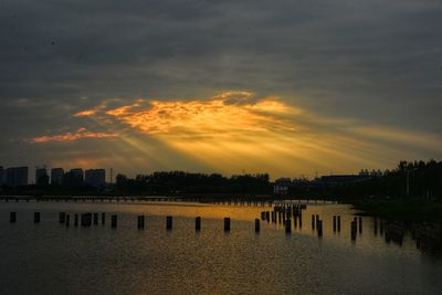 Scenic view of silhouette buildings against sky during sunset