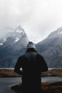 Rear view of woman standing on mountain