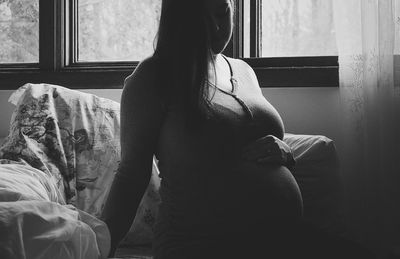 Pregnant woman sitting at home