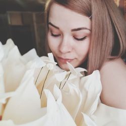 Smiling young woman with white flower bouquet