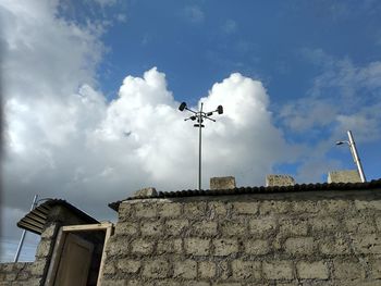 Low angle view of building against cloudy sky