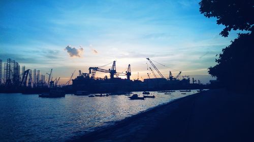 Commercial dock against sky during sunset