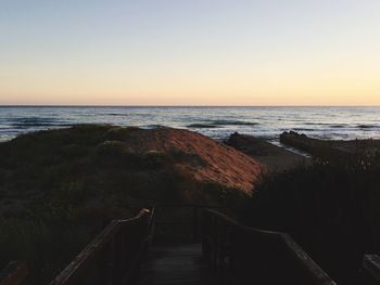 Scenic view of sea against clear sky during sunset